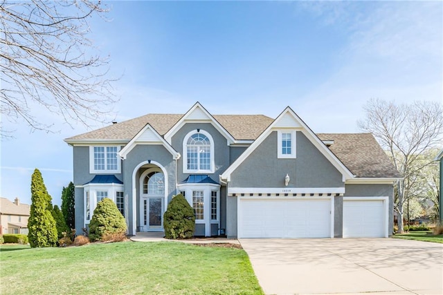 13310 W 129th St, Overland Park, KS 66213 - traditional-style home with concrete driveway, stucco siding, a front yard, and a garage