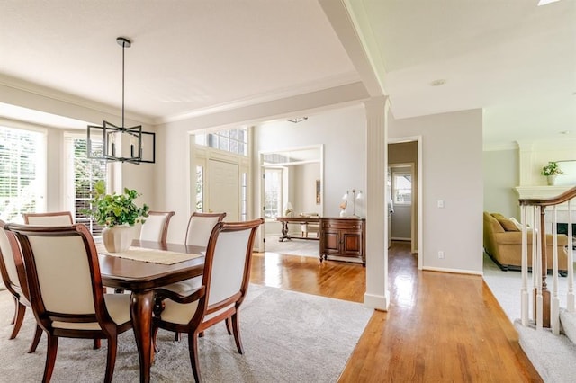 13310 W 129th St, Overland Park, KS 66213 - dining room with ornamental molding, plenty of natural light, light wood-style flooring, a chandelier, and ornate columns