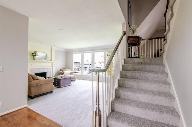 13310 W 129th St, Overland Park, KS 66213 - staircase with a fireplace, baseboards, ornamental molding, and wood finished floors
