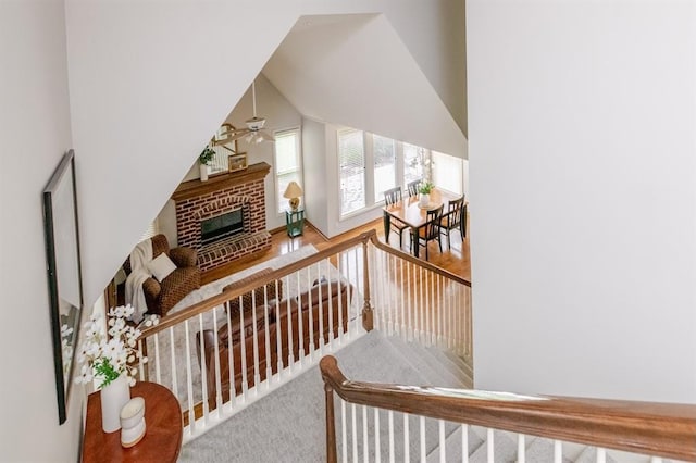 13310 W 129th St, Overland Park, KS 66213 - staircase with a ceiling fan, a brick fireplace, and carpet