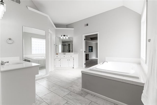 13310 W 129th St, Overland Park, KS 66213 - full bathroom featuring lofted ceiling, a garden tub, two vanities, and marble finish floors