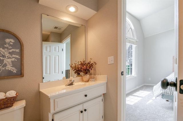 13310 W 129th St, Overland Park, KS 66213 - bathroom featuring toilet, vanity, lofted ceiling, baseboards, and a textured wall