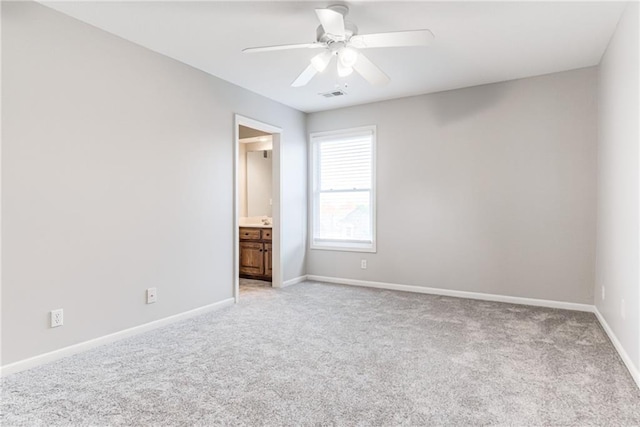 13310 W 129th St, Overland Park, KS 66213 - unfurnished bedroom featuring light carpet, baseboards, ensuite bathroom, and a ceiling fan
