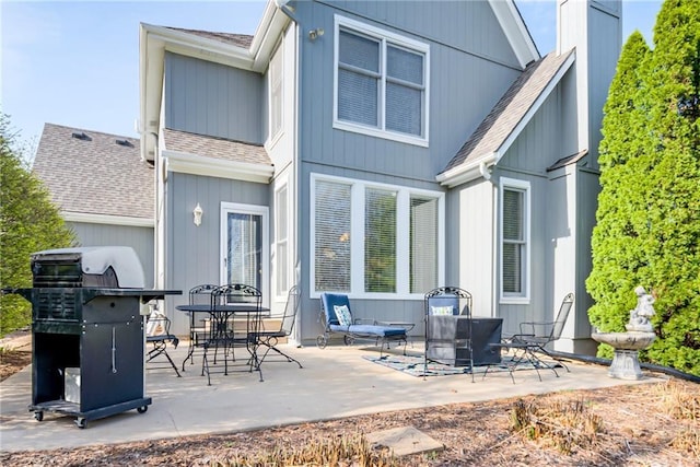 13310 W 129th St, Overland Park, KS 66213 - rear view of house with roof with shingles, a patio, and a chimney