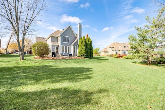 13310 W 129th St, Overland Park, KS 66213 - rear view of property with a lawn, a chimney, and stucco siding