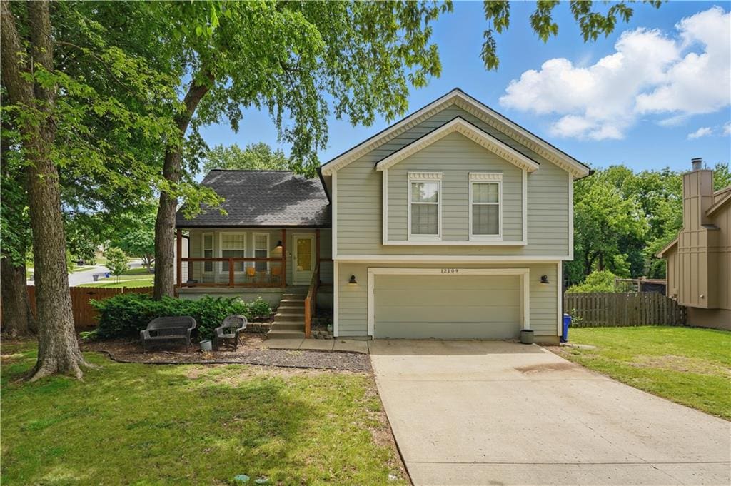 12109 S Acuff Ln, Olathe, KS 66062 - split level home with covered porch, an attached garage, stairway, and driveway