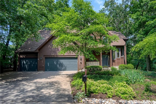 5317 NW Bluff Way, Parkville, MO 64152 - view of front of house featuring a garage, driveway, and roof with shingles