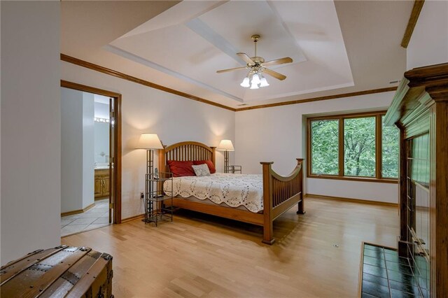 5317 NW Bluff Way, Parkville, MO 64152 - bedroom with a raised ceiling, light wood-type flooring, baseboards, crown molding, and a ceiling fan