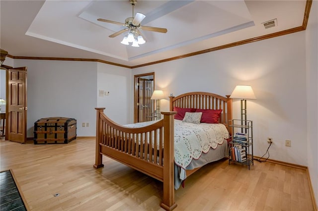 5317 NW Bluff Way, Parkville, MO 64152 - bedroom featuring a raised ceiling, wood finished floors, baseboards, a ceiling fan, and ornamental molding