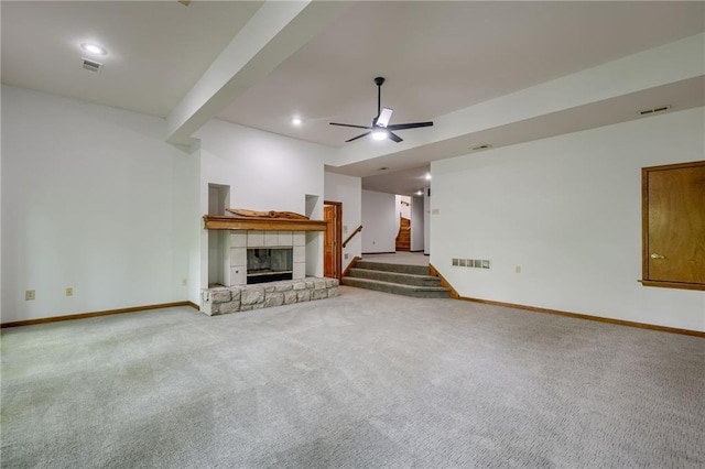 5317 NW Bluff Way, Parkville, MO 64152 - unfurnished living room featuring baseboards, stairway, a ceiling fan, a stone fireplace, and carpet flooring