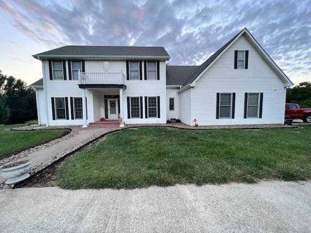 5604 Pleasant Ave, Saint Joseph, MO 64503 - colonial-style house with a balcony and a front yard