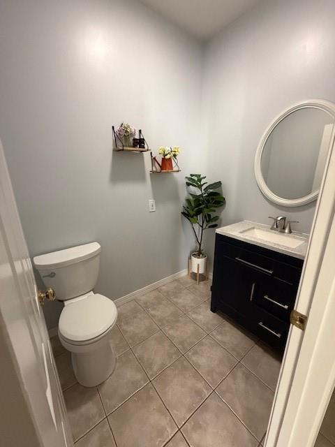 5604 Pleasant Ave, Saint Joseph, MO 64503 - bathroom with vanity, tile patterned flooring, toilet, and baseboards