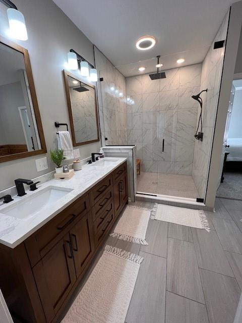 5604 Pleasant Ave, Saint Joseph, MO 64503 - bathroom with a shower stall, double vanity, and recessed lighting