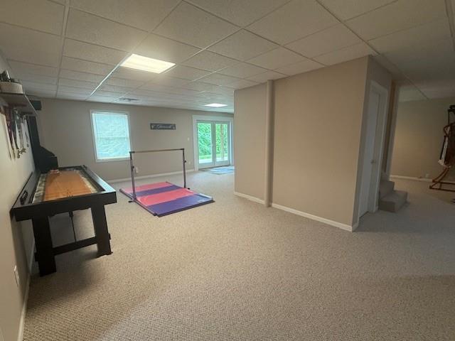 5604 Pleasant Ave, Saint Joseph, MO 64503 - rec room featuring carpet floors, a drop ceiling, and baseboards
