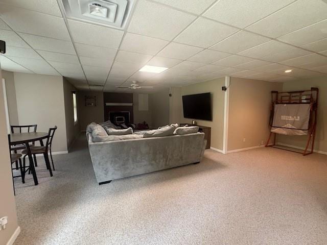5604 Pleasant Ave, Saint Joseph, MO 64503 - living room featuring a paneled ceiling, baseboards, carpet, and a fireplace