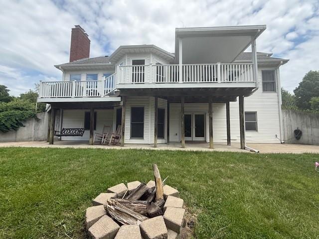 5604 Pleasant Ave, Saint Joseph, MO 64503 - rear view of house featuring french doors, a patio area, a chimney, and a wooden deck
