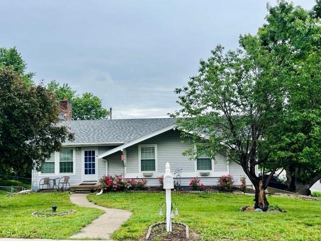 1 N Vine View St, Platte City, MO 64079 - view of front of property featuring a front lawn, a chimney, and roof with shingles