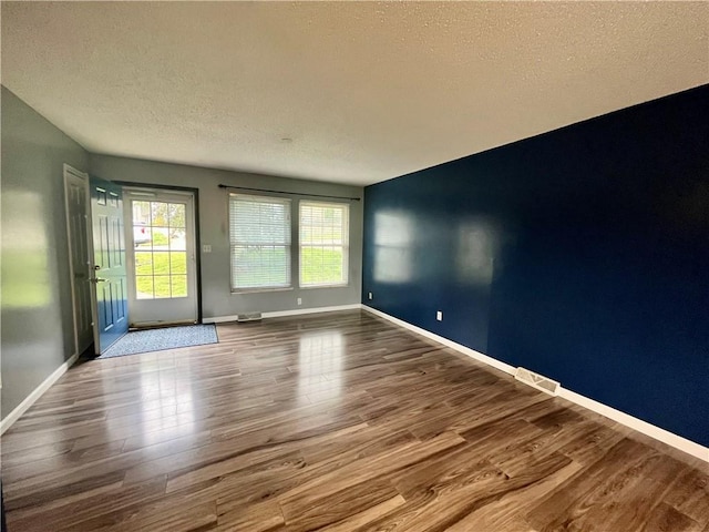 1 N Vine View St, Platte City, MO 64079 - empty room with a textured ceiling, wood finished floors, and baseboards