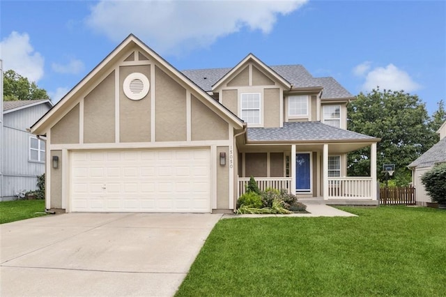 15050 W 145th St, Olathe, KS 66062 - view of front of home featuring covered porch, concrete driveway, an attached garage, a front lawn, and stucco siding