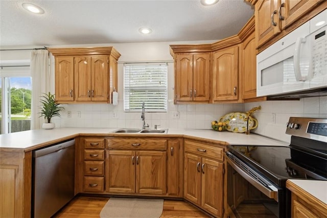 15050 W 145th St, Olathe, KS 66062 - kitchen featuring stainless steel appliances, a sink, plenty of natural light, light countertops, and recessed lighting