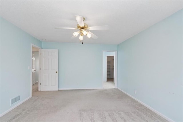 15050 W 145th St, Olathe, KS 66062 - spare room featuring carpet, ceiling fan, and baseboards