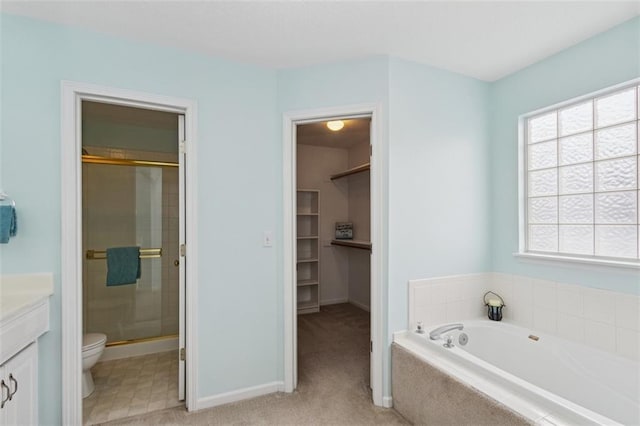 15050 W 145th St, Olathe, KS 66062 - full bathroom featuring vanity, a shower stall, toilet, a garden tub, and a spacious closet