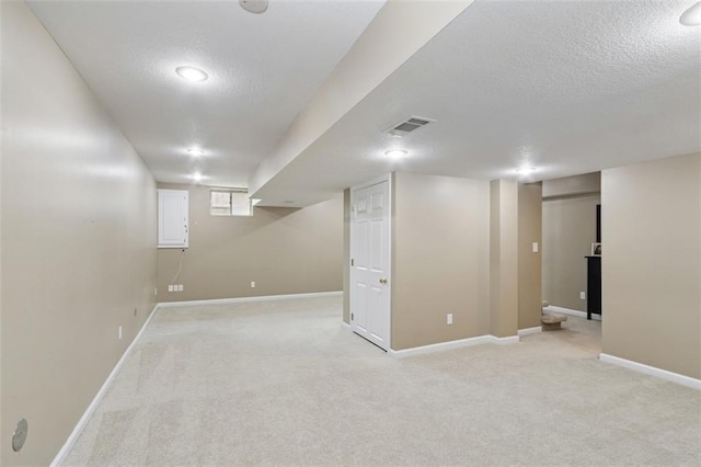 15050 W 145th St, Olathe, KS 66062 - finished basement featuring a textured ceiling, light carpet, and baseboards