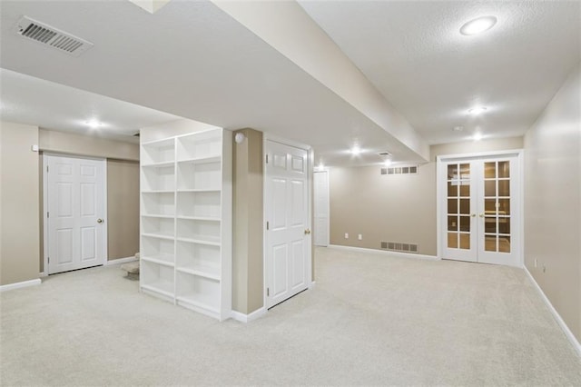 15050 W 145th St, Olathe, KS 66062 - finished basement with carpet flooring, baseboards, french doors, a textured ceiling, and recessed lighting