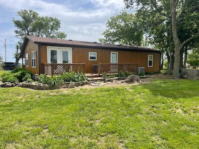 4691 New Hampshire Rd, Bronson, KS 66716 - rear view of house featuring a deck and a lawn
