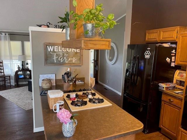4691 New Hampshire Rd, Bronson, KS 66716 - kitchen featuring black fridge with ice dispenser, white gas cooktop, dark wood finished floors, and baseboards
