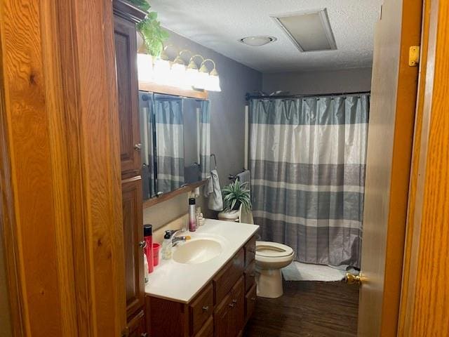 4691 New Hampshire Rd, Bronson, KS 66716 - bathroom featuring vanity, wood finished floors, toilet, and a textured ceiling