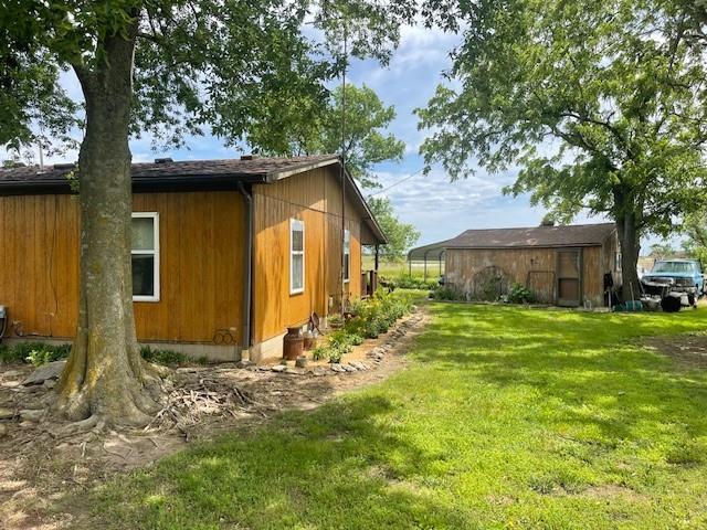 4691 New Hampshire Rd, Bronson, KS 66716 - view of property exterior featuring a lawn