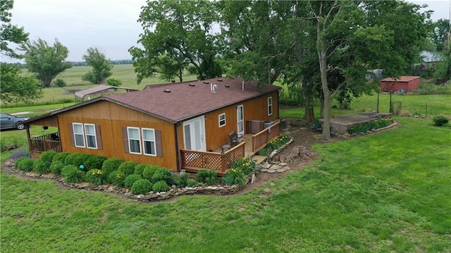 4691 New Hampshire Rd, Bronson, KS 66716 - rear view of property with a wooden deck, a lawn, and roof with shingles