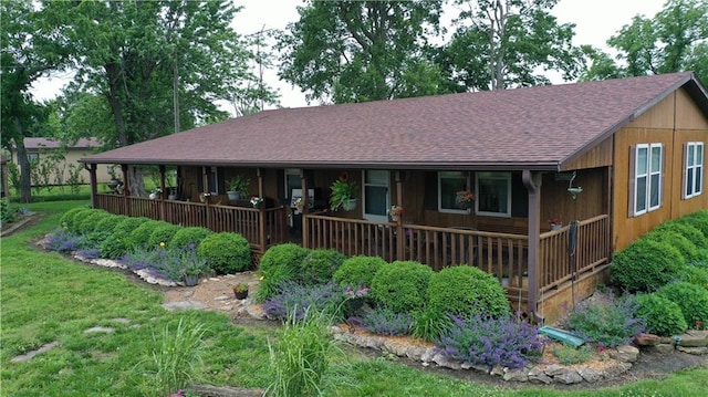 4691 New Hampshire Rd, Bronson, KS 66716 - view of front of house featuring roof with shingles and a porch