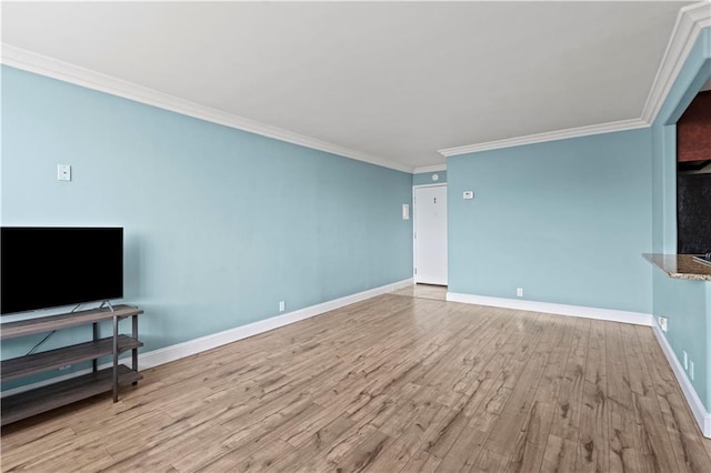 700 E 8th St Unit 11T, Kansas City, MO 64106 - unfurnished living room with wood finished floors, ornamental molding, and baseboards
