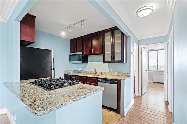 700 E 8th St Unit 11T, Kansas City, MO 64106 - kitchen with stainless steel appliances, track lighting, glass insert cabinets, light stone counters, and baseboards