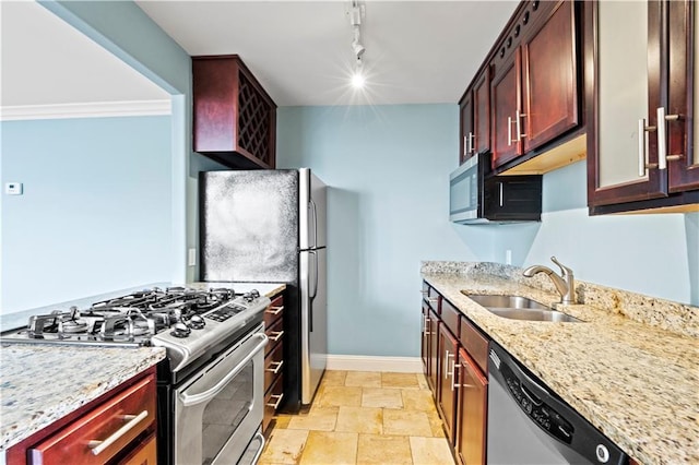 700 E 8th St Unit 11T, Kansas City, MO 64106 - kitchen with appliances with stainless steel finishes, a sink, baseboards, light stone counters, and light stone finish floors