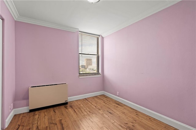 700 E 8th St Unit 11T, Kansas City, MO 64106 - spare room with ornamental molding, light wood-style floors, and baseboards