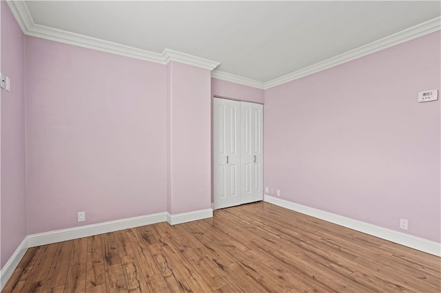700 E 8th St Unit 11T, Kansas City, MO 64106 - unfurnished room with baseboards, wood finished floors, and ornamental molding