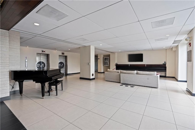 700 E 8th St Unit 11T, Kansas City, MO 64106 - living room with light tile patterned floors, baseboards, and a drop ceiling