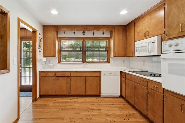 5407 W 64th Ter, Prairie Village, KS 66208 - kitchen with white appliances, brown cabinets, a sink, light wood finished floors, and light countertops