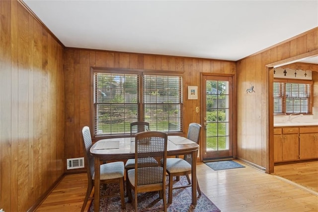 5407 W 64th Ter, Prairie Village, KS 66208 - dining area featuring wood walls, light wood-type flooring, and baseboards