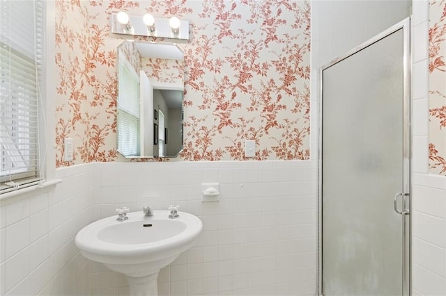5407 W 64th Ter, Prairie Village, KS 66208 - bathroom featuring wallpapered walls, a wainscoted wall, a shower stall, and tile walls