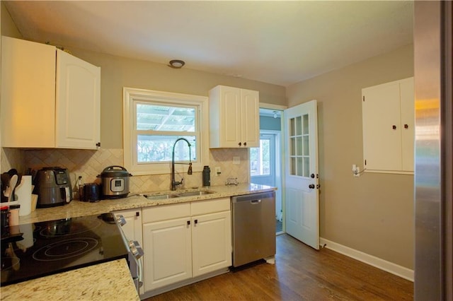 7610 NE Bacon Rd, Cameron, MO 64429 - kitchen featuring stainless steel dishwasher, a sink, range with electric stovetop, tasteful backsplash, and wood finished floors