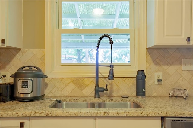 7610 NE Bacon Rd, Cameron, MO 64429 - kitchen with a sink, decorative backsplash, white cabinets, light stone counters, and dishwashing machine