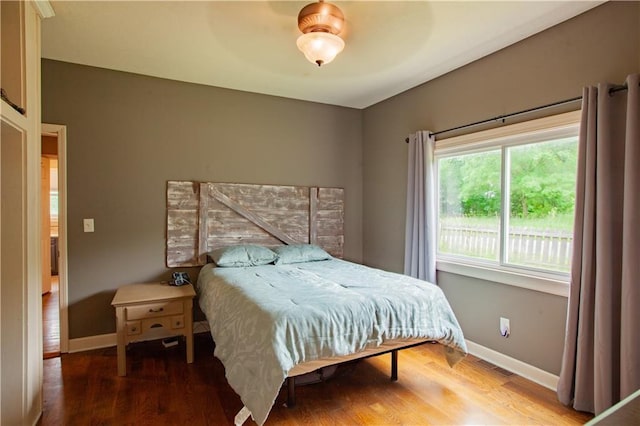 7610 NE Bacon Rd, Cameron, MO 64429 - bedroom with baseboards, wood finished floors, and a ceiling fan