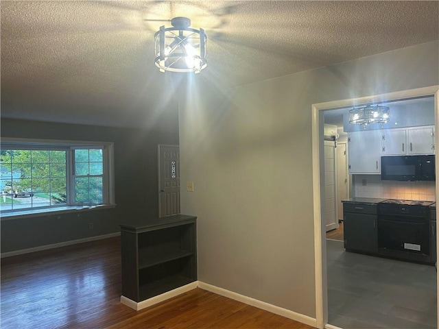 1923 Seneca St, Leavenworth, KS 66048 - interior space featuring dark wood-style flooring and a textured ceiling