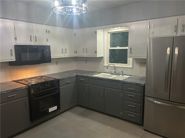 1923 Seneca St, Leavenworth, KS 66048 - kitchen with black appliances, dark countertops, white cabinets, and tasteful backsplash