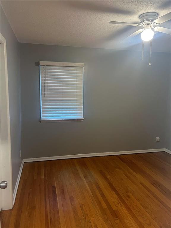 1923 Seneca St, Leavenworth, KS 66048 - spare room with a ceiling fan, wood finished floors, and a textured ceiling