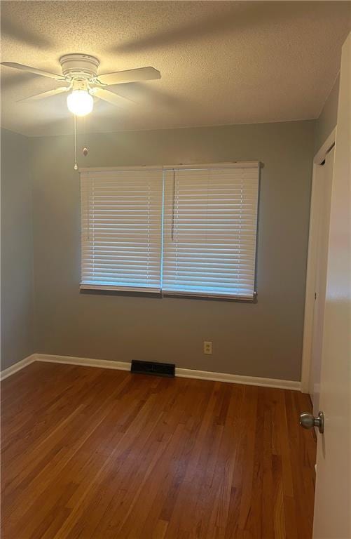 1923 Seneca St, Leavenworth, KS 66048 - empty room with wood finished floors, a ceiling fan, and a textured ceiling